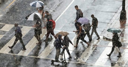 Pedestrians cross K Street in Northwest Washington on a rainy day in October 2018 by Robert Miller for The Washington Post